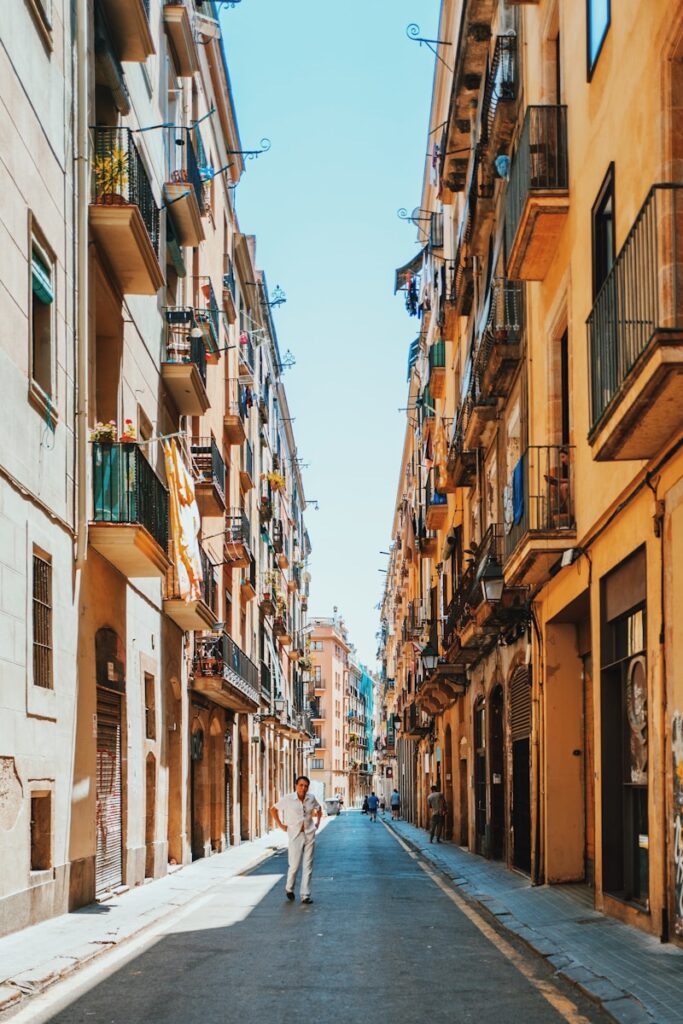 person walking between buildings